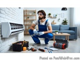 In this image, we can see a man wearing blue overalls and safety goggles, kneeling on the floor in front of an air conditioni...
