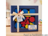 The image is of a gift box with a blue background and a white ribbon tied around it. The box is rectangular in shape and has...