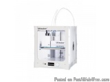 The image shows a white Ultimaker 3D printer. It is a small, rectangular device with a handle on the top for easy carrying. T...