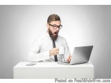 The image shows a man sitting at a desk with a laptop in front of him. He is wearing a white shirt and a black tie. He has a...