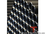 The image shows a stack of black pipes or tubes. The pipes are arranged in a neat and orderly manner, with each pipe slightly...