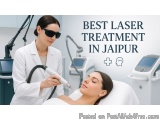 The image shows a woman lying on a white bed with her eyes closed, receiving a laser treatment on her face. A woman in a whit...