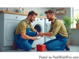 The image shows two young men in a laundry room, kneeling on the floor in front of a washing machine. They are both wearing b...