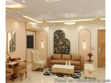 The image shows a modern living room with a high ceiling and recessed lighting. The walls are painted in a light pink color a...
