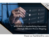 The image shows a person's hand holding a pen and pointing to a computer screen with multiple lines and icons on it. The back...