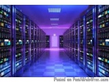 The image shows a long corridor in a data center. The corridor is lined with rows of servers on both sides, each with multipl...