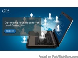 The image shows a laptop with a blue background. The laptop is open and the screen is turned on, displaying a world map. On t...
