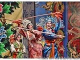 The image shows a group of three people performing a traditional Chinese dance. The person in the center is a woman wearing a...