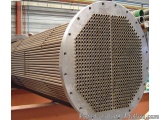 The image shows a large cylindrical metal pipe with a perforated design. The pipe appears to be made of steel or aluminum and...