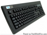 The image shows a black keyboard with a blue and white logo on the top left corner. The keyboard has a rectangular shape with...