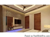 The image shows a modern and luxurious bedroom with a high ceiling and a ceiling fan. The walls are painted in a light beige...