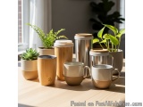 The image shows a group of six ceramic mugs and a stainless steel travel mug on a wooden table. There are six mugs in total,...