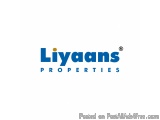 The image is a logo for a company called Liyaans Properties. The logo is written in a modern, sans-serif font and is in a blu...