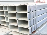 The image shows a stack of white metal pipes or tubes. The pipes are arranged in a horizontal manner and are stacked on top o...