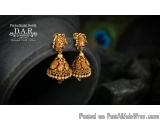 The image shows a pair of traditional Indian earrings. The earrings are made of gold and have a jhumka-style design with intr...