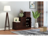 The image shows a modern living room with a wooden floor lamp on the left side and a wooden dresser on the right side. The dr...