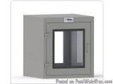The image shows a gray metal cabinet with a glass door. The cabinet has a rectangular shape with a flat top and a flat bottom...