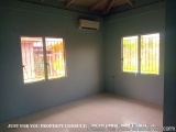 The image shows an empty room with two windows on the right side of the room. The walls are painted in a light blue color and...