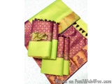 The image shows a set of three folded sarees in different colors - green, purple, and orange. The sarees are made of a woven...