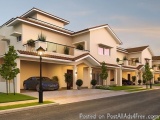 The image is a 3D rendering of a modern two-story house. The house has a white exterior with a brown roof and a balcony on th...