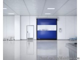 The image shows an empty room with white walls and floor. The room has a modern and minimalist design with a large blue scree...