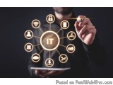 The image shows a man holding a tablet with the word "IT" in the center. The man is wearing a black suit and is holding a pen...