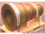 The image shows a large, cylindrical object, which appears to be a part of a larger machine or machinery. It is made of metal...