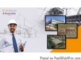 The image is an advertisement for PC Bodiwala & Associates, a construction company. It features a man wearing a white hard ha...