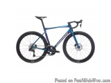 The image is of a blue and black road bike. The bike has a sleek design with a black saddle and handlebars. The frame is made...
