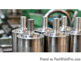 The image shows a group of four stainless steel cylindrical objects with a threaded head. The objects appear to be made of a...