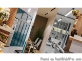The image is a collage of three photographs of a modern office space. The first photograph on the left shows a blue door with...