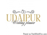 The image is a logo for a wedding planner named "Udaipur Wedding Planner". The logo is written in a cursive font in a golden...