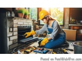 In this image, we can see a young woman wearing a yellow hard hat and blue overalls, kneeling on the floor in front of a fire...