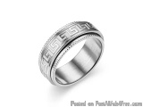 The image is of a silver ring with a Greek key design on it. The ring appears to be made of metal and has a smooth, polished...