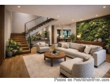 The image shows a modern living room with a high ceiling and a staircase on the left side. The staircase has a wooden handrai...