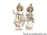 The image shows a pair of Hindu deities, Agrawal Moorti Bhandar, standing side by side. They are both wearing traditional Ind...