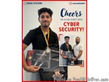 The image is an advertisement for Resec Systems and Hackersprey. It features a young man holding a certificate with a medal a...