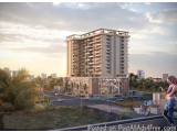 The image is a 3D rendering of a modern apartment building. The building is tall and has multiple floors and balconies. It is...