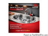 The image is an advertisement for a Grafdoer kitchen sink. The sink is made of stainless steel and has a red faucet with a pu...