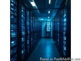 The image shows a long corridor in a data center. The corridor is lined with rows of servers, each with multiple rows of data...