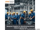 The image shows a group of men working in a manufacturing factory. They are all wearing blue uniforms and yellow hard hats, a...
