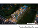The image is an aerial view of a modern apartment complex at night. The complex is located on a hilltop and is surrounded by...