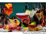 The image shows a collection of different types of cocktails on a bar counter. There are six glasses in total, arranged in a...