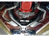 The image shows the underside of a car, specifically the exhaust system. The exhaust system is made up of two large, elongate...