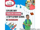 The image is an advertisement for Toddlers Ashiana, a top playway school in Chandigarh, India. The background of the image is...
