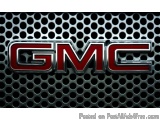 The image is a close-up of the GMC logo on a black background. The logo is in the center of the image and is made up of the l...