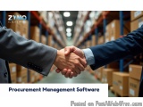 The image shows two men shaking hands in a warehouse. The man on the left is wearing a suit and tie and is holding the other...