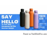 The image shows four water bottles of different colors - black, white, orange, and purple - arranged in a row. The bottles ar...