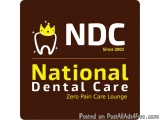 The image is a logo for National Dental Care, a dental care company. The logo is rectangular in shape and has a dark brown ba...