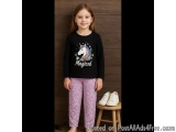 The image shows a young girl standing in front of a wooden wall with a pair of white sneakers on a small wooden stool next to...